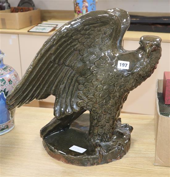 A large green glazed stoneware model of an eagle height 41cm